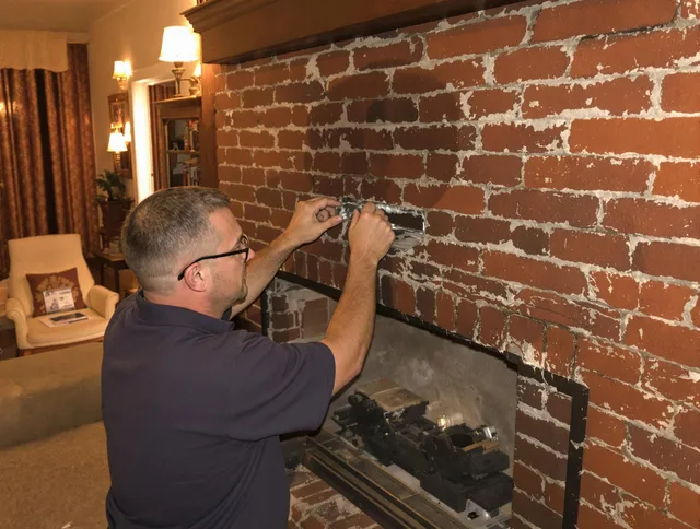 Plainfield Chimney Sweep expert fixing a fireplace in Plainfield, CT